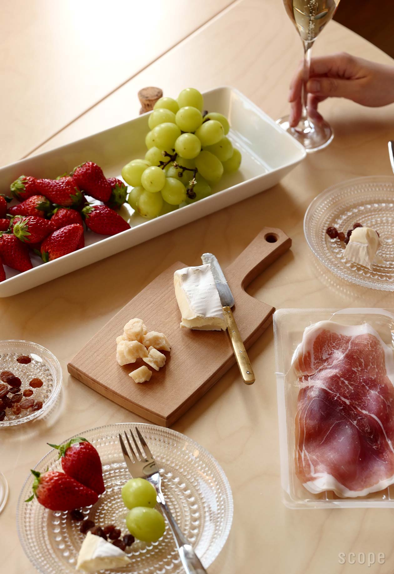 アーモンドとブドウを添えたハードチーズとソフトチーズのチーズ盛り合わせを石皿に盛り付けました。黒の背景に2つのフルーツフォーク。マウンドフレンチブリー チーズとチーズボードの側面図。の写真素材・画像素材 Image 182235233